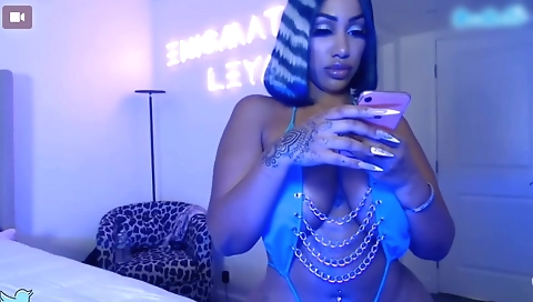 Ebony stripper in black lingerie strips and shows off